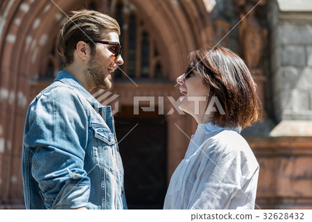 Cheery young couple travelling around city places Cheery young couple travelling around city places 32628432