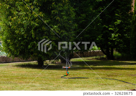 Garden sprinkler watering grass Garden sprinkler watering grass 32628675