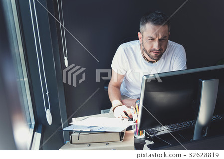 Elegant manager is laboring with attention Elegant manager is laboring with attention 32628819