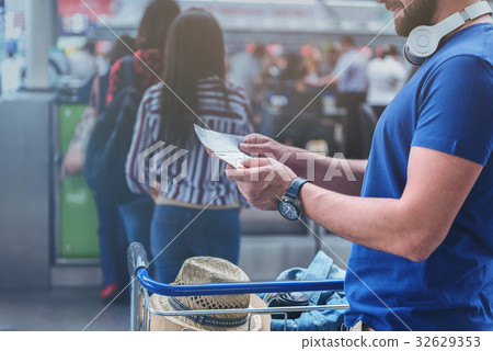 Cheerful man keeping boarding documents 32629353