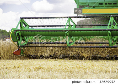 combine harvester working on a wheat field. combine harvester working on a wheat field. 32629952
