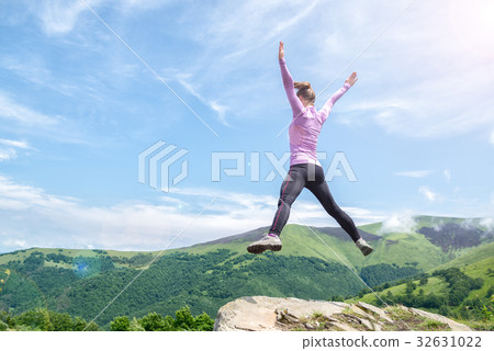 Young woman jumping in the mountains Young woman jumping in the mountains 32631022