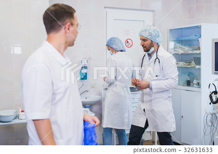 Surgeon gathered with his team of doctors before 32631633