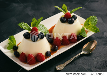 Italian dessert  with berries and caramel sauce. 32632058