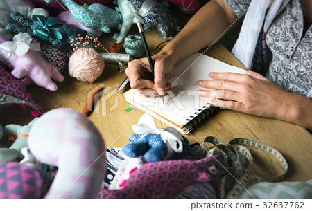 Closeup of hands drawing doll pattern handicraft 32637762