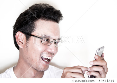 Man using smartphone with smile and happy Man using smartphone with smile and happy 32641845