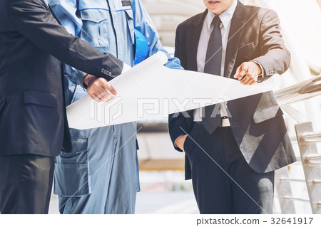 Engineer and business man discuss about blueprint Engineer and business man discuss about blueprint 32641917