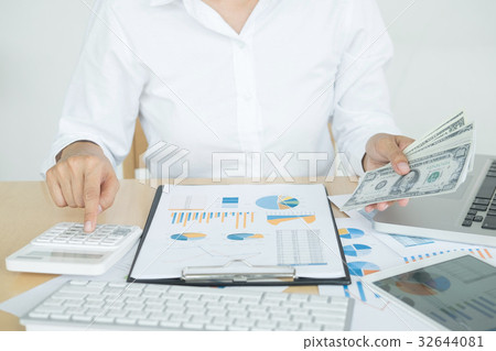 close up hand of man counting money with calculator and making n close up hand of man counting money with calculator and making n 32644081