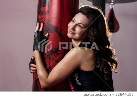 beautiful brunette woman boxer near red punching beautiful brunette woman boxer near red punching 32644195