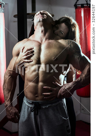 Woman passionately embraces muscular man in the Woman passionately embraces muscular man in the 32644197