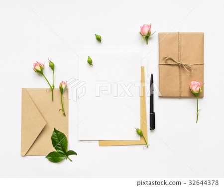 Letter, envelope and gift on white, flat lay Letter, envelope and gift on white, flat lay 32644378