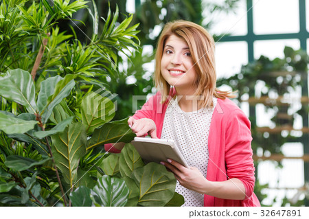 Young florist at flower shop 32647891