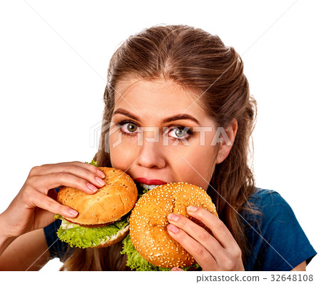 Woman eating two hamburgers. Girl bite of very big 32648108