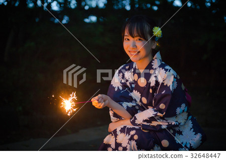 A woman in a yukata roaring fireworks A woman in a yukata roaring fireworks 32648447