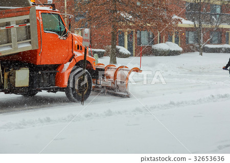 Tractor clears the way after heavy snowfall. 32653636