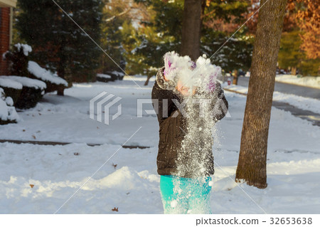 little happy girl playing at snowy winter outdoor 32653638