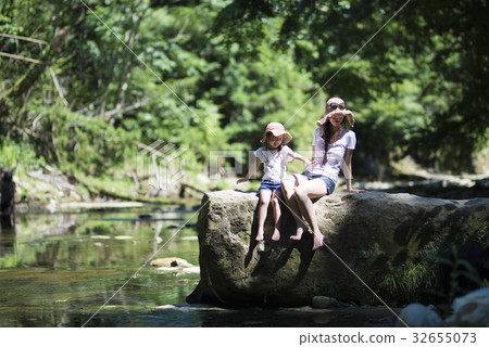 Parent and child playing on mountain stream Parent and child playing on mountain stream 32655073