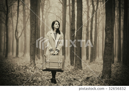 portrait of a young woman with a suitcase 32656832