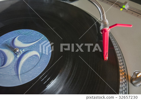 Playing vinyl on turntable 32657230