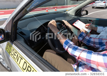 Learner driver student driving car with instructor 32658331