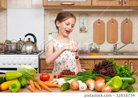 girl cooking in home kitchen fruit and vegetables girl cooking in home kitchen fruit and vegetables 32658734