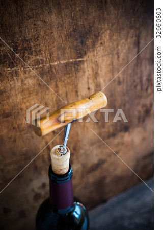 Bottle Wine with Corkscrew on Wooden Background Bottle Wine with Corkscrew on Wooden Background 32660803