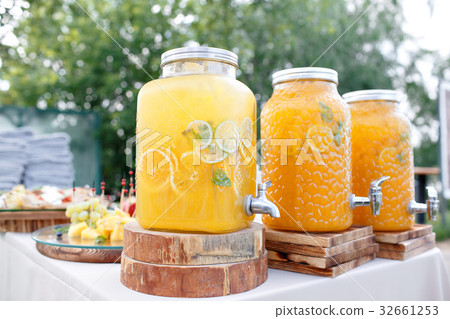 Jar of tasty fresh orange lemonade with ice and Jar of tasty fresh orange lemonade with ice and 32661253