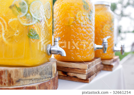 Jar of tasty fresh orange lemonade with ice and Jar of tasty fresh orange lemonade with ice and 32661254