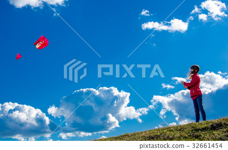 Young girl with kite flying in the sky Young girl with kite flying in the sky 32661454