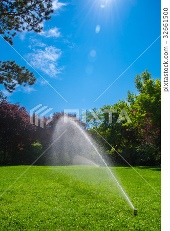 Lawn Sprinkler with Water and Blue Sky 32661500