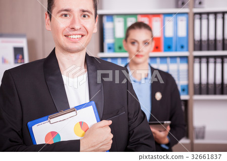 Portrait of businessman with a folder in hands and Portrait of businessman with a folder in hands and 32661837