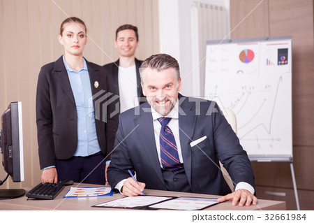 Adult businessman writing on folder with papper 32661984