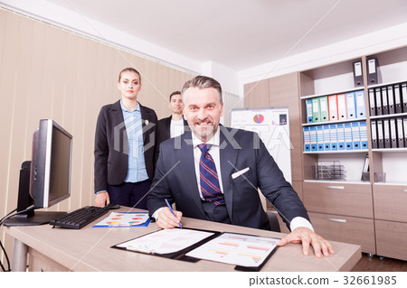 Adult businessman writing on folder with papper 32661985