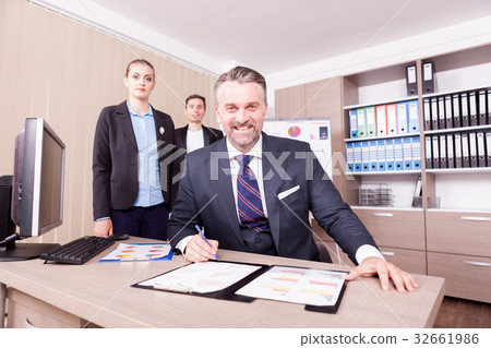 Adult businessman writing on folder with papper 32661986
