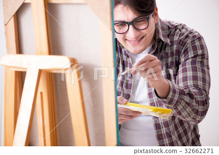 Young male artist drawing pictures in bright 32662271