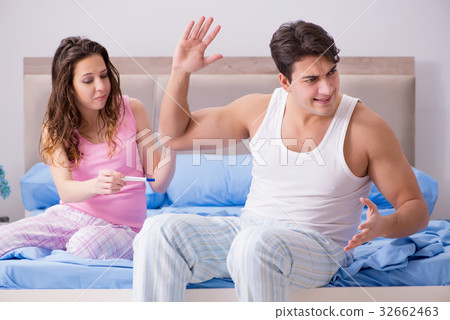 Young family with pregnancy test results 32662463