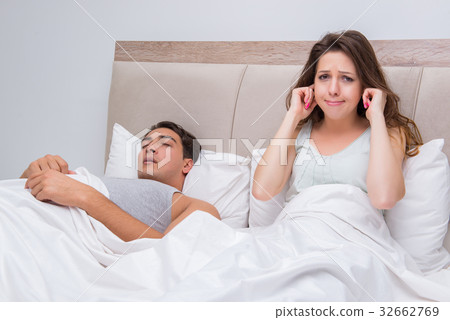 Woman having trouble with husband snoring 32662769