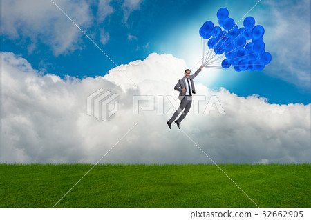 Businessman flying balloons on bright day 32662905