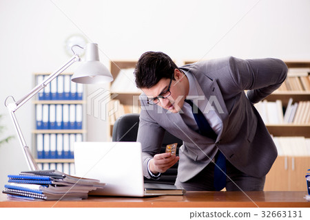 Businessman feeling pain in the office Businessman feeling pain in the office 32663131