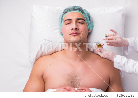 Handsome man in spa massage concept Handsome man in spa massage concept 32663183