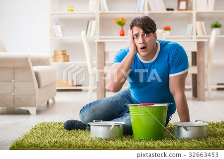 Man at home dealing with neighbor flood leak 32663453