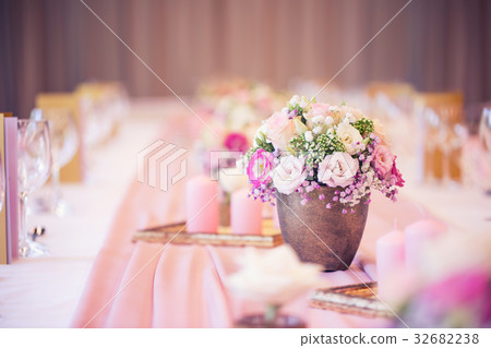 Beautiful table set with flowers and glass cups. Beautiful table set with flowers and glass cups. 32682238