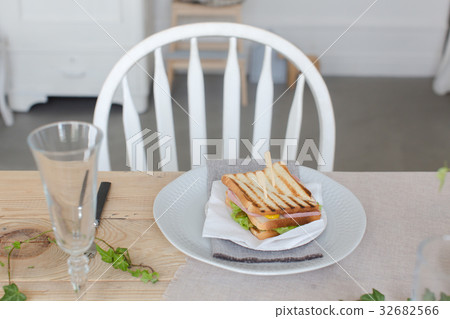 Plate with sandwich on beautifully served table Plate with sandwich on beautifully served table 32682566