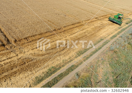 Agriculture machine harvesting crop in field 32682946