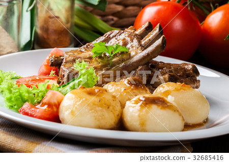 Pork spareribs served with silesian noodles Pork spareribs served with silesian noodles 32685416