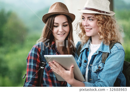 Two girls in hats traveling through ruins 32688983