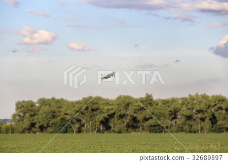 Hovering drone taking pictures of green hills. Hovering drone taking pictures of green hills. 32689897