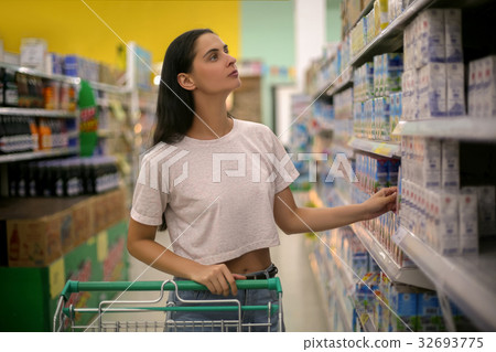 woman shopping in a grocery store supermarket 32693775