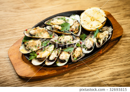 Baked mussels with cheese Baked mussels with cheese 32693815