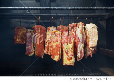 Hanging ham in the smokehouse 32694188